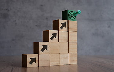 Wooden blocks with arrows and target
