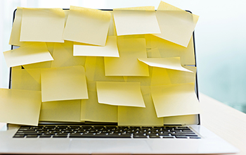 Laptop screen covered in blank sticky notes
