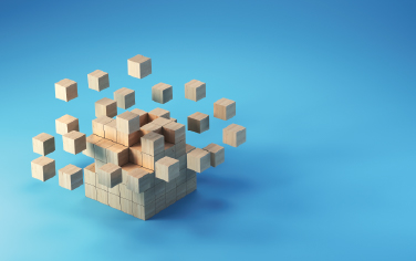A tower of wooden building blocks with some of the blocks floating above