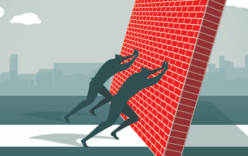 Two silhouetted figured push over brick wall